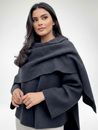 Women’s oversized warm coat featuring a draped, fold-over neckline, relaxed cocoon silhouette and asymmetric hem. Soft-touch construction adds cosy warmth without bulk, layering smoothly over knitwear, dresses or tailoring for refined everyday style.
