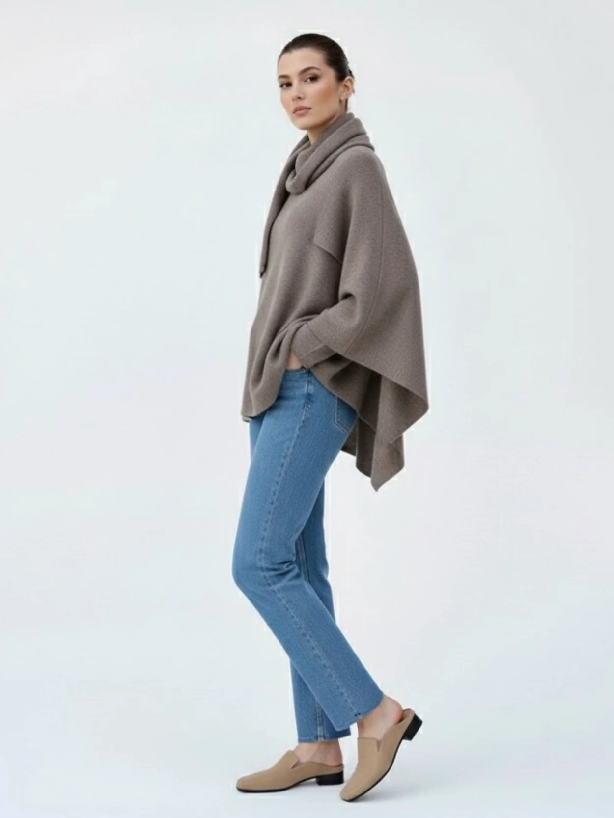 Women’s oversized warm coat featuring a draped, fold-over neckline, relaxed cocoon silhouette and asymmetric hem. Soft-touch construction adds cosy warmth without bulk, layering smoothly over knitwear, dresses or tailoring for refined everyday style.