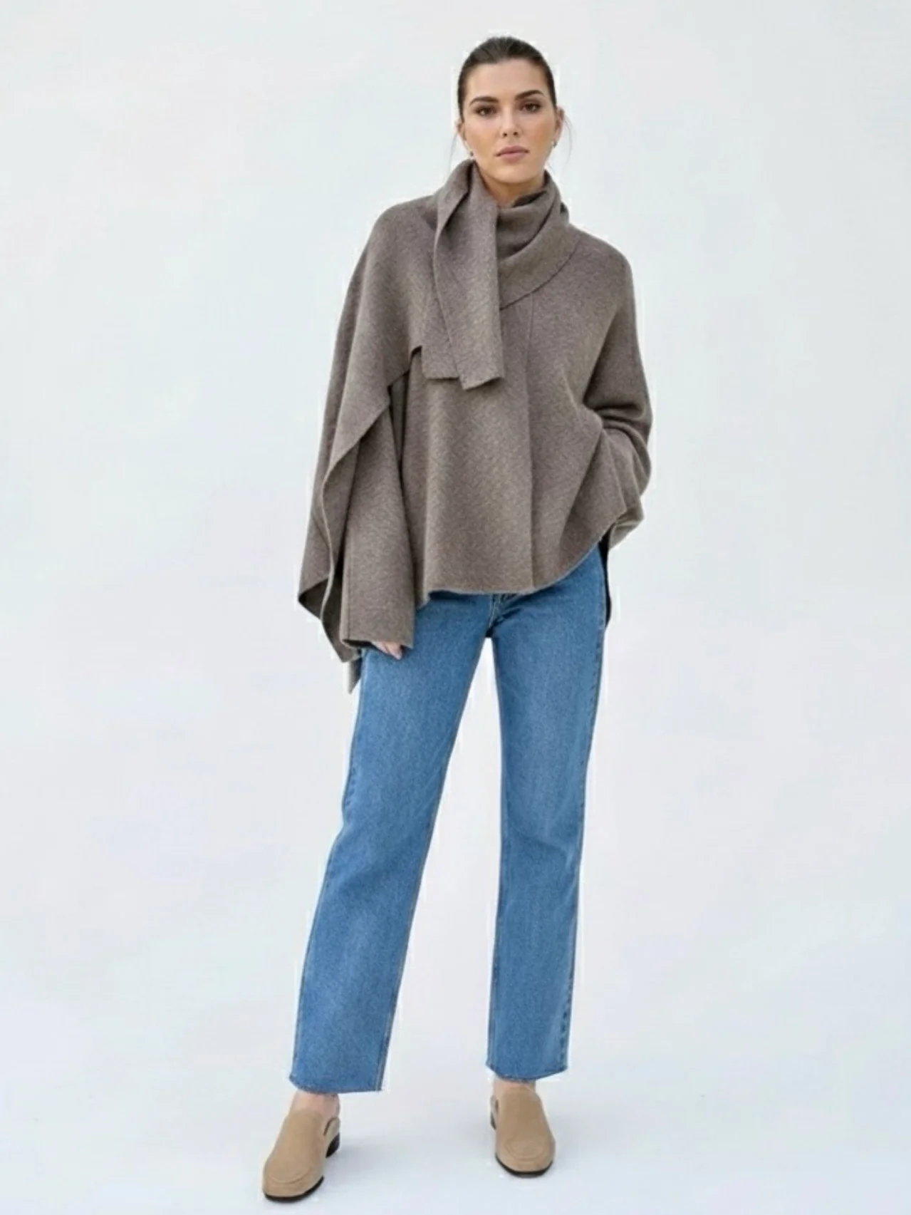 Women’s oversized warm coat featuring a draped, fold-over neckline, relaxed cocoon silhouette and asymmetric hem. Soft-touch construction adds cosy warmth without bulk, layering smoothly over knitwear, dresses or tailoring for refined everyday style.