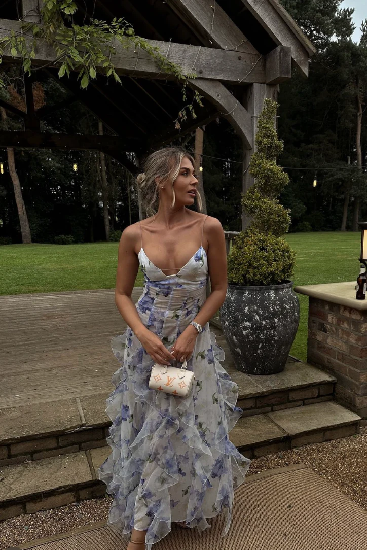 Jackie Floral Maxi Dress with adjustable spaghetti straps, softly shaped bodice and flowing ruffle layers. Lightweight, sheer fabric and a refined side slit create romantic movement; finished with a concealed zip for a clean, polished look.