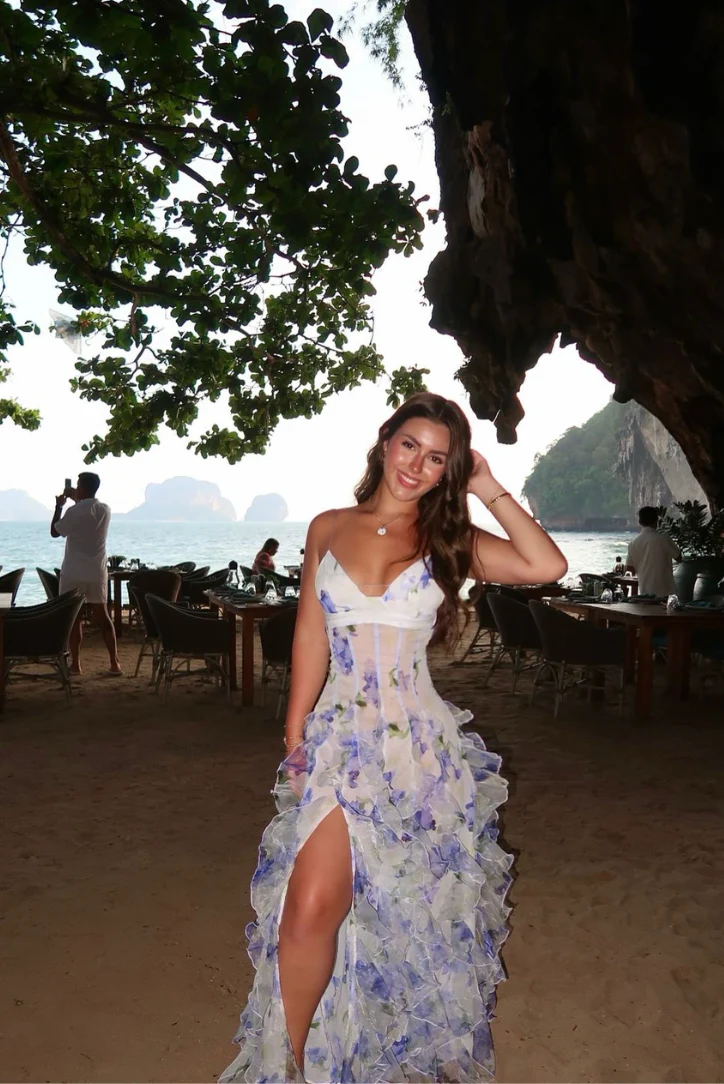 Jackie Floral Maxi Dress with adjustable spaghetti straps, softly shaped bodice and flowing ruffle layers. Lightweight, sheer fabric and a refined side slit create romantic movement; finished with a concealed zip for a clean, polished look.