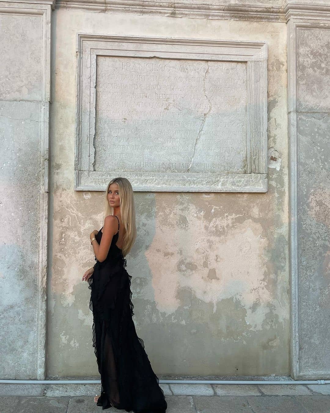 Women’s elegant tulle maxi dress with slender straps, open back and ruched waist. Floaty, ruffled texture and subtle side slit deliver graceful movement. A floor-skimming hem elongates for polished wedding or evening looks.