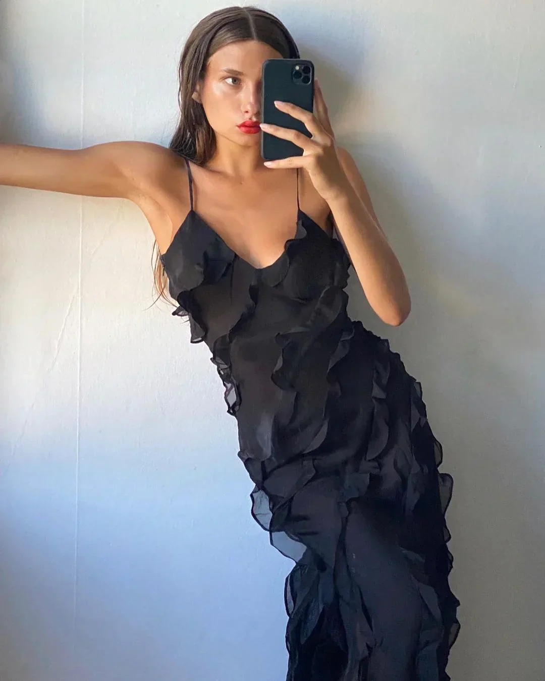 Women’s elegant tulle maxi dress with slender straps, open back and ruched waist. Floaty, ruffled texture and subtle side slit deliver graceful movement. A floor-skimming hem elongates for polished wedding or evening looks.