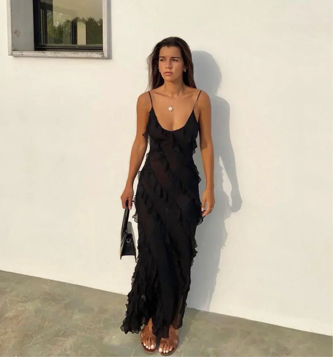 Women’s elegant tulle maxi dress with slender straps, open back and ruched waist. Floaty, ruffled texture and subtle side slit deliver graceful movement. A floor-skimming hem elongates for polished wedding or evening looks.