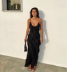 Women’s elegant tulle maxi dress with slender straps, open back and ruched waist. Floaty, ruffled texture and subtle side slit deliver graceful movement. A floor-skimming hem elongates for polished wedding or evening looks.
