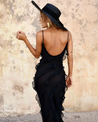 Women’s elegant tulle maxi dress with slender straps, open back and ruched waist. Floaty, ruffled texture and subtle side slit deliver graceful movement. A floor-skimming hem elongates for polished wedding or evening looks.