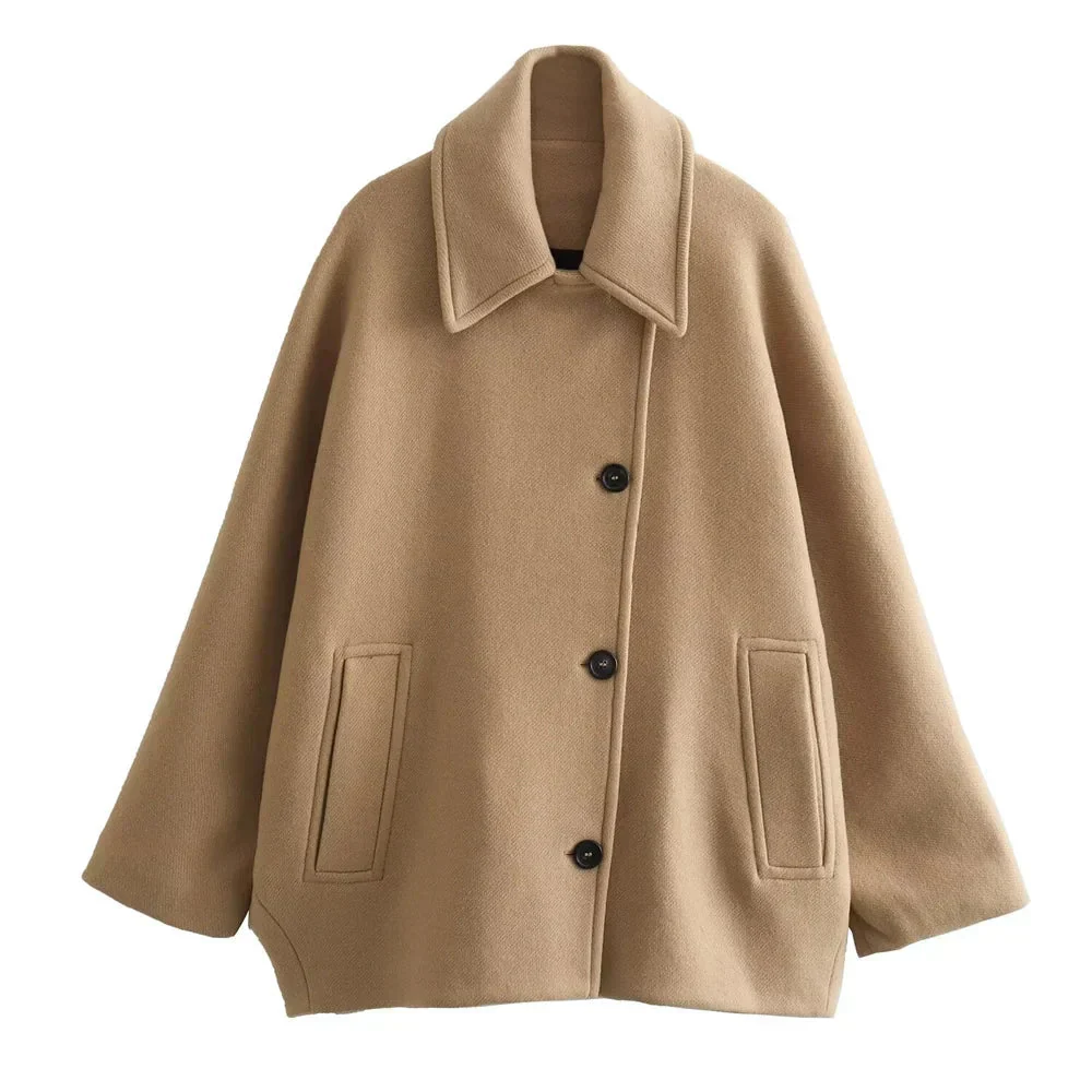 Women’s oversized collared coat in a hip-length cut with dropped shoulders, side slits, clean button front and deep hand pockets. Minimalist lines create a smooth drape over knitwear or dresses, delivering a refined, easy-to-style winter layer.