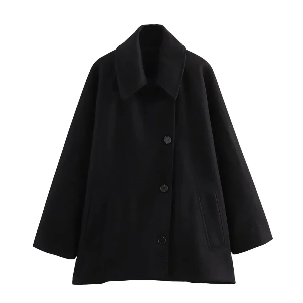 Women’s oversized collared coat in a hip-length cut with dropped shoulders, side slits, clean button front and deep hand pockets. Minimalist lines create a smooth drape over knitwear or dresses, delivering a refined, easy-to-style winter layer.