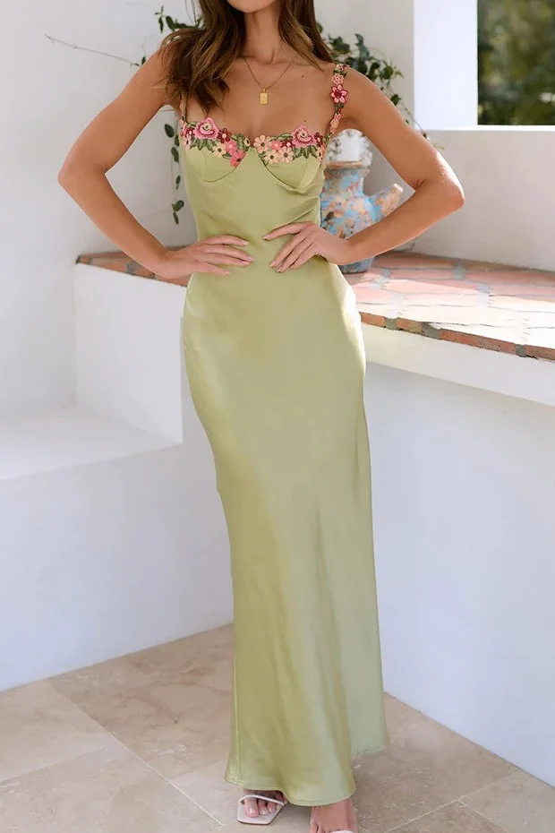 Floral satin-effect maxi dress featuring underwire cups, delicate embroidery along the bust and thin adjustable spaghetti straps. Soft, lightweight 100% polyester with a subtle sheen and a body-hugging, elongated silhouette ideal for weddings and evenings.