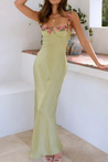 Floral satin-effect maxi dress featuring underwire cups, delicate embroidery along the bust and thin adjustable spaghetti straps. Soft, lightweight 100% polyester with a subtle sheen and a body-hugging, elongated silhouette ideal for weddings and evenings.