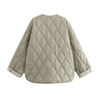 Soft beige quilted oversized jacket featuring wave-pattern stitching, rounded neckline, full front zip and two roomy front pockets. Polyester shell with lightweight fibre fill provides warmth without bulk and a relaxed drape for easy layering in cooler seasons.