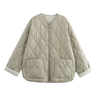 Soft beige quilted oversized jacket featuring wave-pattern stitching, rounded neckline, full front zip and two roomy front pockets. Polyester shell with lightweight fibre fill provides warmth without bulk and a relaxed drape for easy layering in cooler seasons.