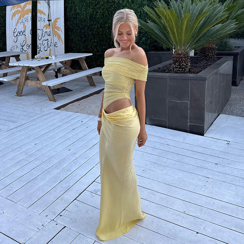 Off-shoulder mesh maxi dress featuring a ruched neckline, sheer waist accent and draped, sarong-like overlay over a column skirt. Body-skimming silhouette with pull-on ease, ideal for cocktails, soirées and chic summer events.