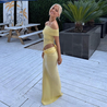Off-shoulder mesh maxi dress featuring a ruched neckline, sheer waist accent and draped, sarong-like overlay over a column skirt. Body-skimming silhouette with pull-on ease, ideal for cocktails, soirées and chic summer events.