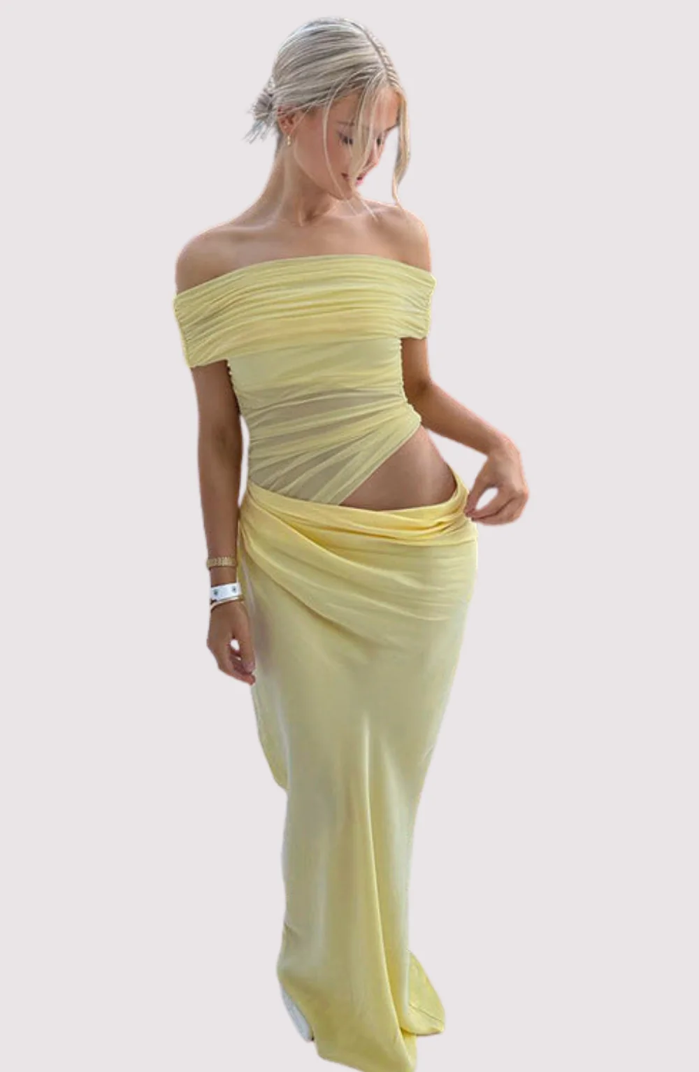 Off-shoulder mesh maxi dress featuring a ruched neckline, sheer waist accent and draped, sarong-like overlay over a column skirt. Body-skimming silhouette with pull-on ease, ideal for cocktails, soirées and chic summer events.