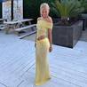 Off-shoulder mesh maxi dress featuring a ruched neckline, sheer waist accent and draped, sarong-like overlay over a column skirt. Body-skimming silhouette with pull-on ease, ideal for cocktails, soirées and chic summer events.