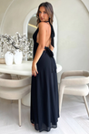 Margo halter maxi dress featuring a plunging V neckline, waist-defining band, invisible back zip, and double lining. Floor-length skirt with side slit for movement and allure, ideal for weddings, parties, and formal nights.