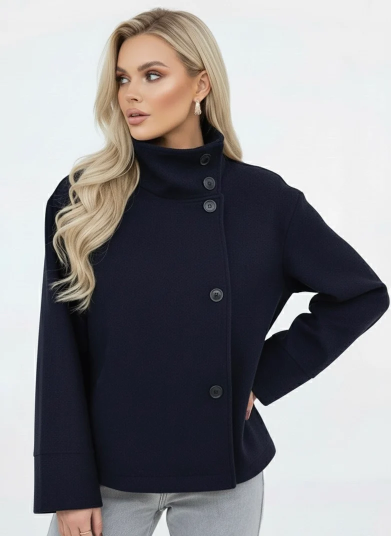 Martha High-Neck Wool-Blend Jacket featuring a structured stand collar, asymmetric button closure, smooth inner lining and a relaxed, slightly cropped silhouette. A warm yet polished layer that pairs with tailored trousers or high-waisted denim for transitional days.