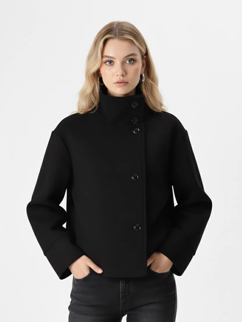 Martha High-Neck Wool-Blend Jacket featuring a structured stand collar, asymmetric button closure, smooth inner lining and a relaxed, slightly cropped silhouette. A warm yet polished layer that pairs with tailored trousers or high-waisted denim for transitional days.