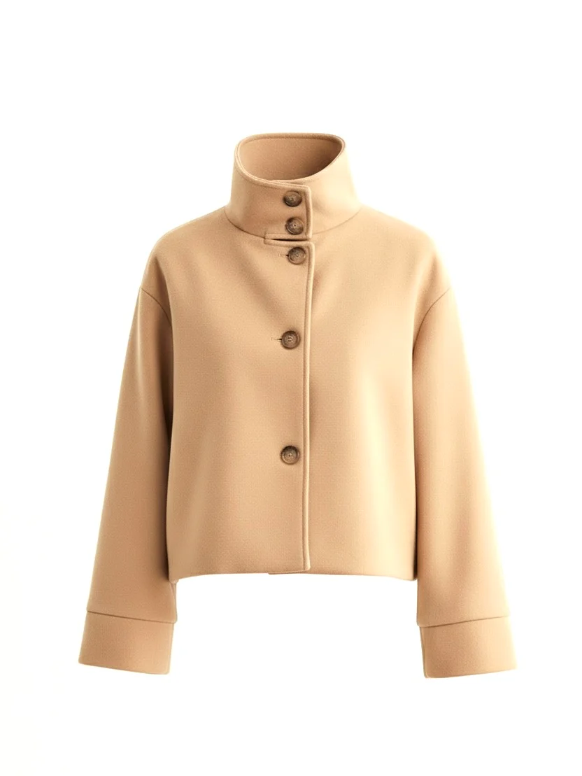 Martha High-Neck Wool-Blend Jacket featuring a structured stand collar, asymmetric button closure, smooth inner lining and a relaxed, slightly cropped silhouette. A warm yet polished layer that pairs with tailored trousers or high-waisted denim for transitional days.