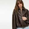 Mary Women’s Black Faux Leather Oversized Shirt Jacket with zip front, dropped shoulders and soft lining; relaxed silhouette for layering as a shirt or light jacket; minimalist design for versatile day-to-night styling.