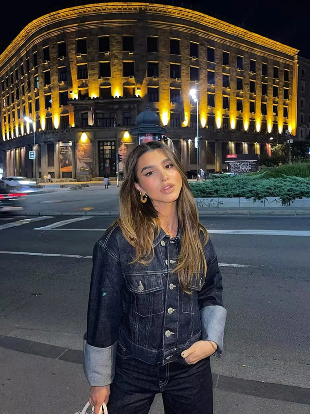 Dark indigo jacket with a boxy silhouette, rolled-up long sleeves, button-through front and neat chest pockets. Hip-skimming length and subtle paneled construction create a clean, modern layer over tees, knits or dresses for city-ready styling.