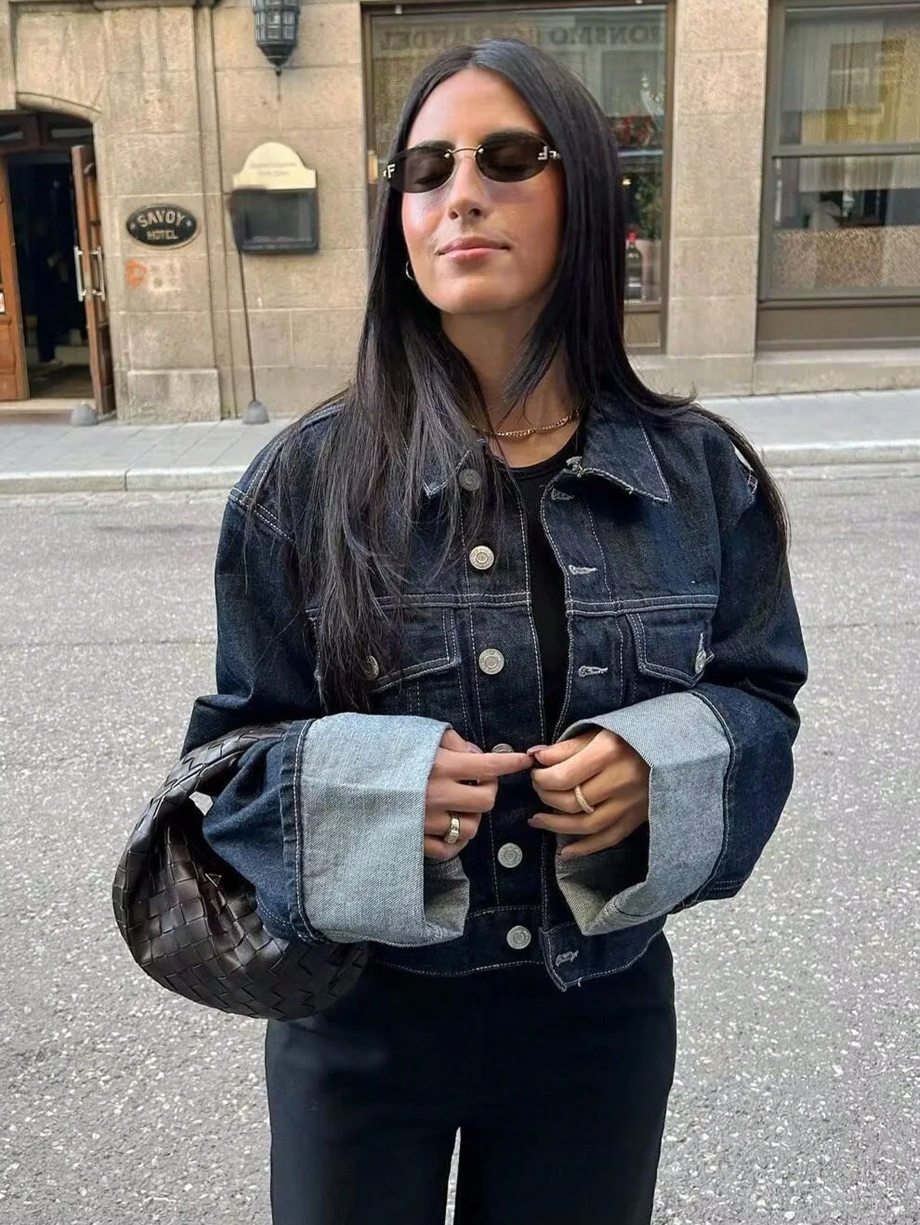 Dark indigo jacket with a boxy silhouette, rolled-up long sleeves, button-through front and neat chest pockets. Hip-skimming length and subtle paneled construction create a clean, modern layer over tees, knits or dresses for city-ready styling.