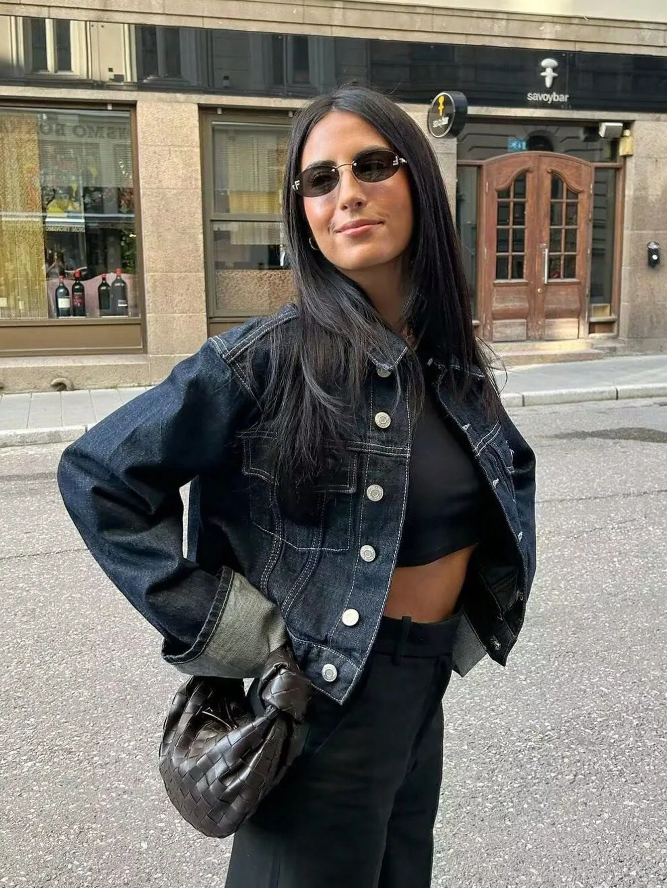 Dark indigo jacket with a boxy silhouette, rolled-up long sleeves, button-through front and neat chest pockets. Hip-skimming length and subtle paneled construction create a clean, modern layer over tees, knits or dresses for city-ready styling.