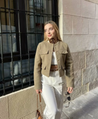 Vintage-inspired cropped jacket in a clean, round-neck design, finished with gold-tone buttons and four flap pockets. Tailored, waist-skimming silhouette in softly structured fabric adds a refined layer over dresses, denim or high-waisted trousers.