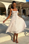 Meredith Corset Midi Dress in floral print poplin featuring a sweetheart neckline, gathered bust and structured, waist-cinching bodice. Softly flared midi skirt adds movement; romantic, versatile piece for weddings, brunches and summer parties.