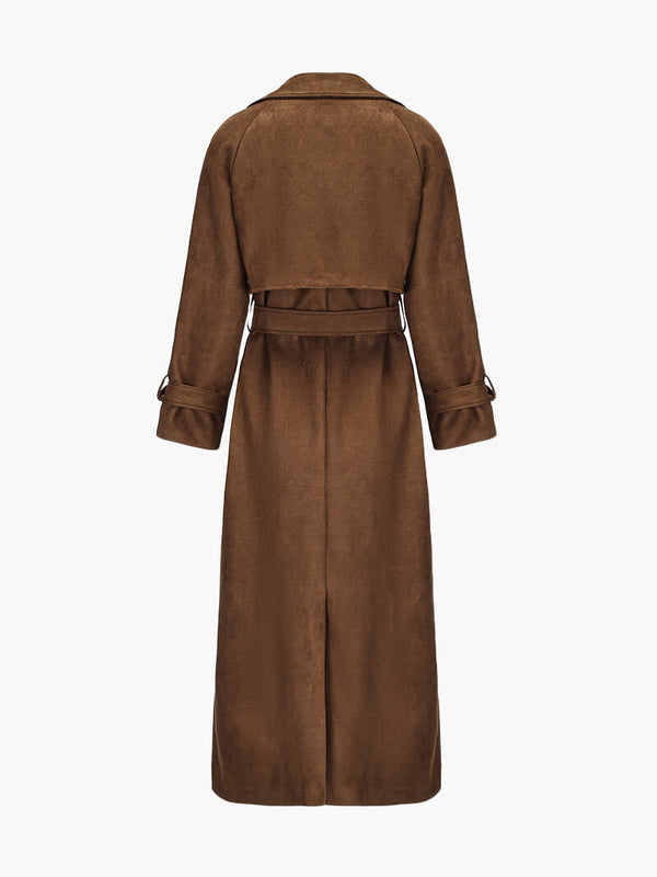Molly faux suede trenchcoat featuring a velvety-soft finish, relaxed longline silhouette, buttoned front and waist-defining tie belt. Drapes comfortably over knits or dresses, adding refined, feminine style for transitional weather.