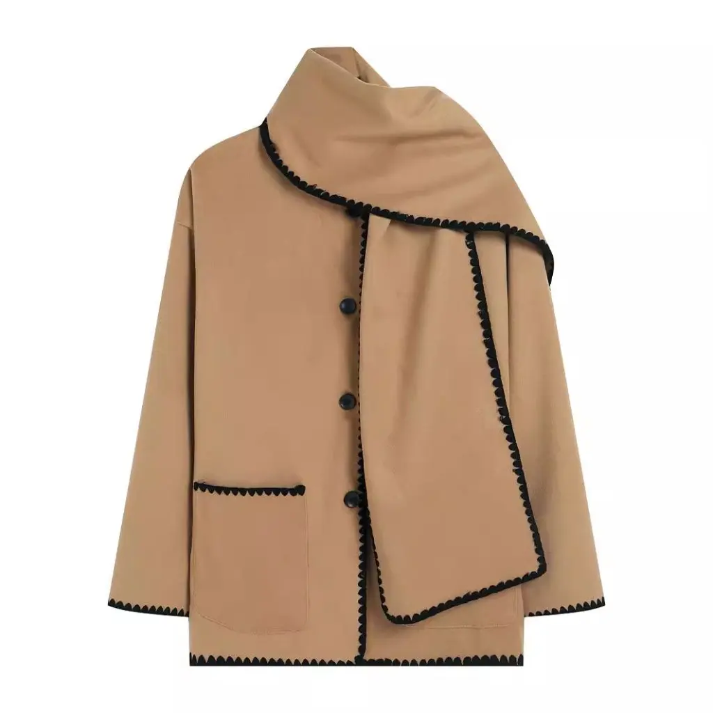 Nellie black wool-blend cape coat featuring a flowing silhouette with white contrast trim, front button fastening, practical side pockets and an attached oversized scarf collar. Warm, elegant outer layer that drapes over denim, knitwear or evening looks.