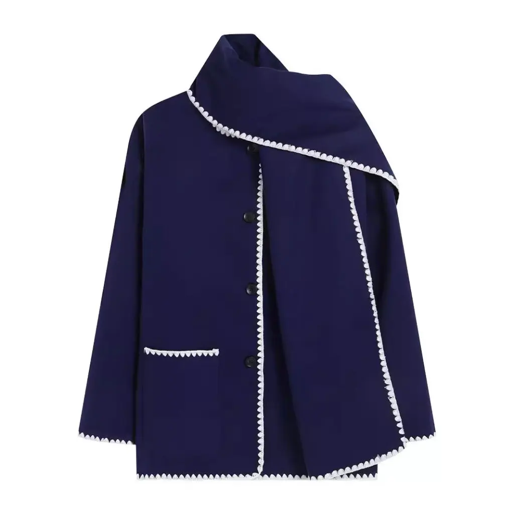 Nellie black wool-blend cape coat featuring a flowing silhouette with white contrast trim, front button fastening, practical side pockets and an attached oversized scarf collar. Warm, elegant outer layer that drapes over denim, knitwear or evening looks.