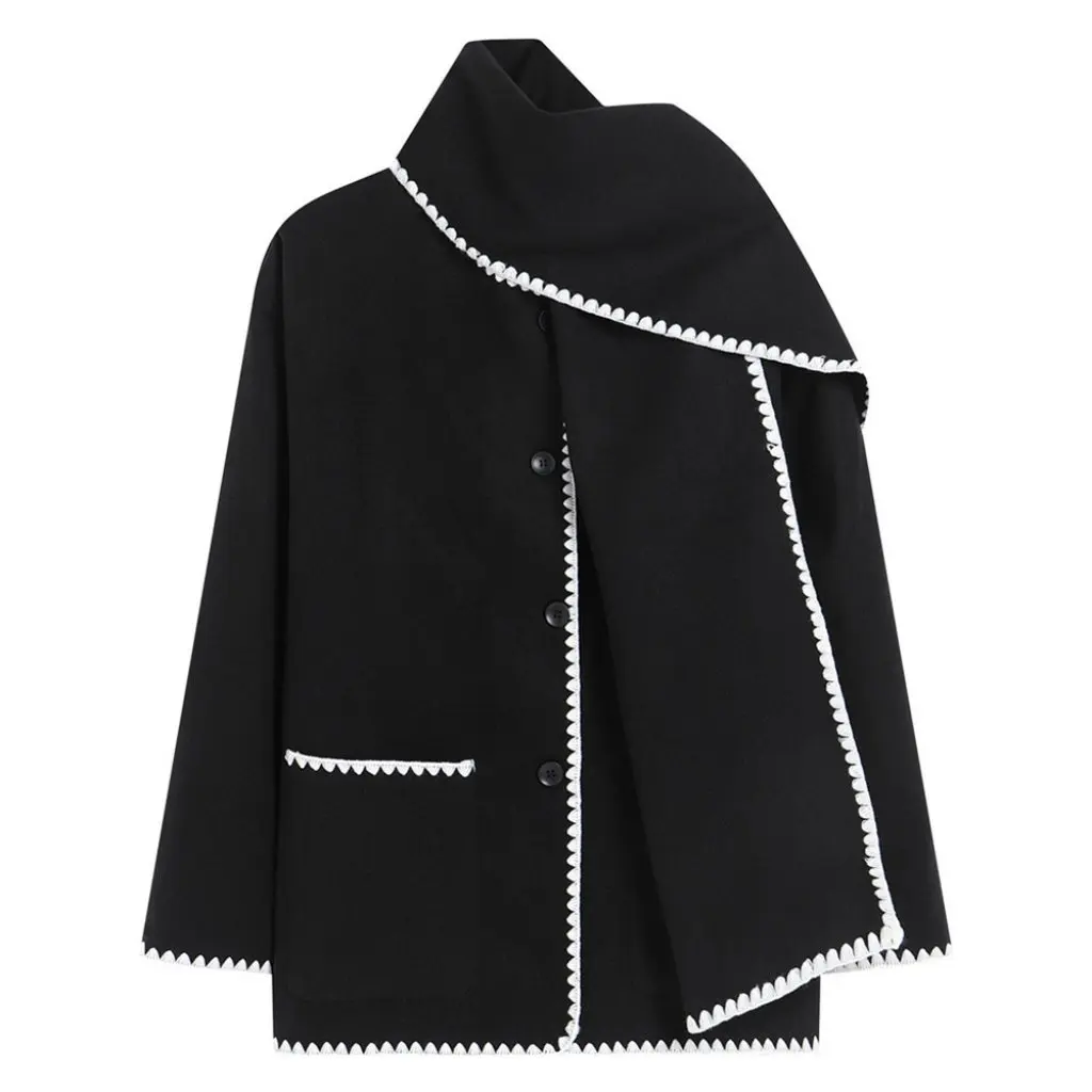 Nellie black wool-blend cape coat featuring a flowing silhouette with white contrast trim, front button fastening, practical side pockets and an attached oversized scarf collar. Warm, elegant outer layer that drapes over denim, knitwear or evening looks.