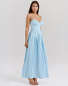 Nerina strapless pleated maxi dress with a structured bustier and seashell-pleated cups, fitted waist, and flowing pleated skirt. Soft, lightweight 100% polyester with subtle shine, ideal for resort dinners, beach weddings, and summer events.