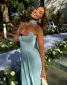 Nerina strapless pleated maxi dress with a structured bustier and seashell-pleated cups, fitted waist, and flowing pleated skirt. Soft, lightweight 100% polyester with subtle shine, ideal for resort dinners, beach weddings, and summer events.