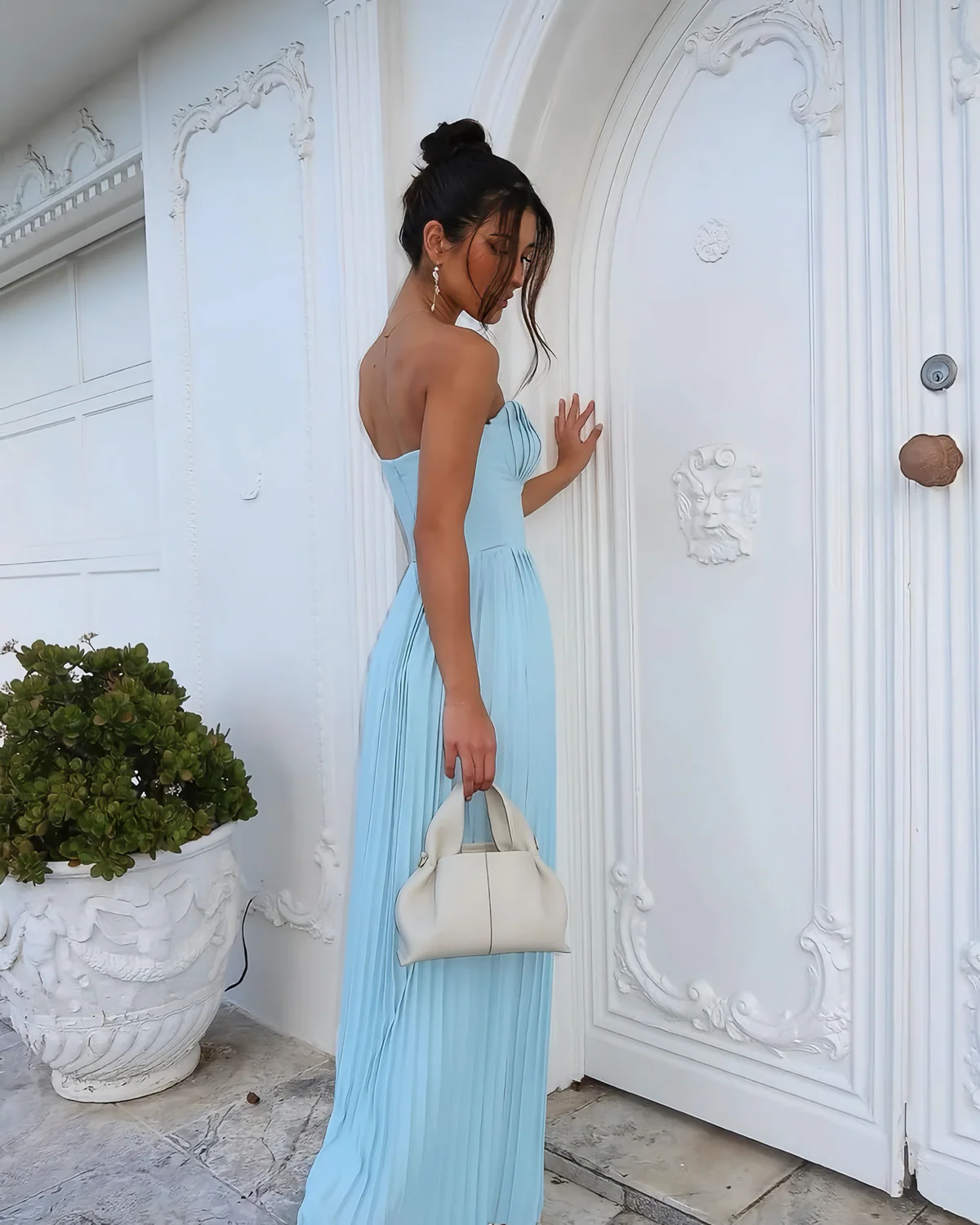 Nerina strapless pleated maxi dress with a structured bustier and seashell-pleated cups, fitted waist, and flowing pleated skirt. Soft, lightweight 100% polyester with subtle shine, ideal for resort dinners, beach weddings, and summer events.