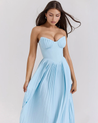 Nerina strapless pleated maxi dress with a structured bustier and seashell-pleated cups, fitted waist, and flowing pleated skirt. Soft, lightweight 100% polyester with subtle shine, ideal for resort dinners, beach weddings, and summer events.