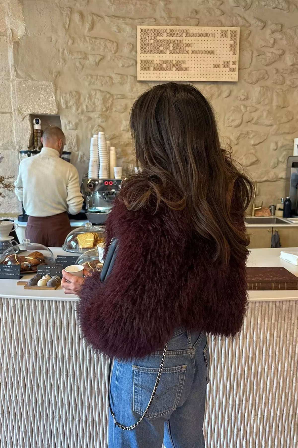 Cropped fluffy jacket in deep wine with a refined notch lapel and subtly voluminous sleeves. Plush, cosy texture and hip-skimming length create a chic layer over denim or evening dresses, adding warm, modern elegance for cooler days.