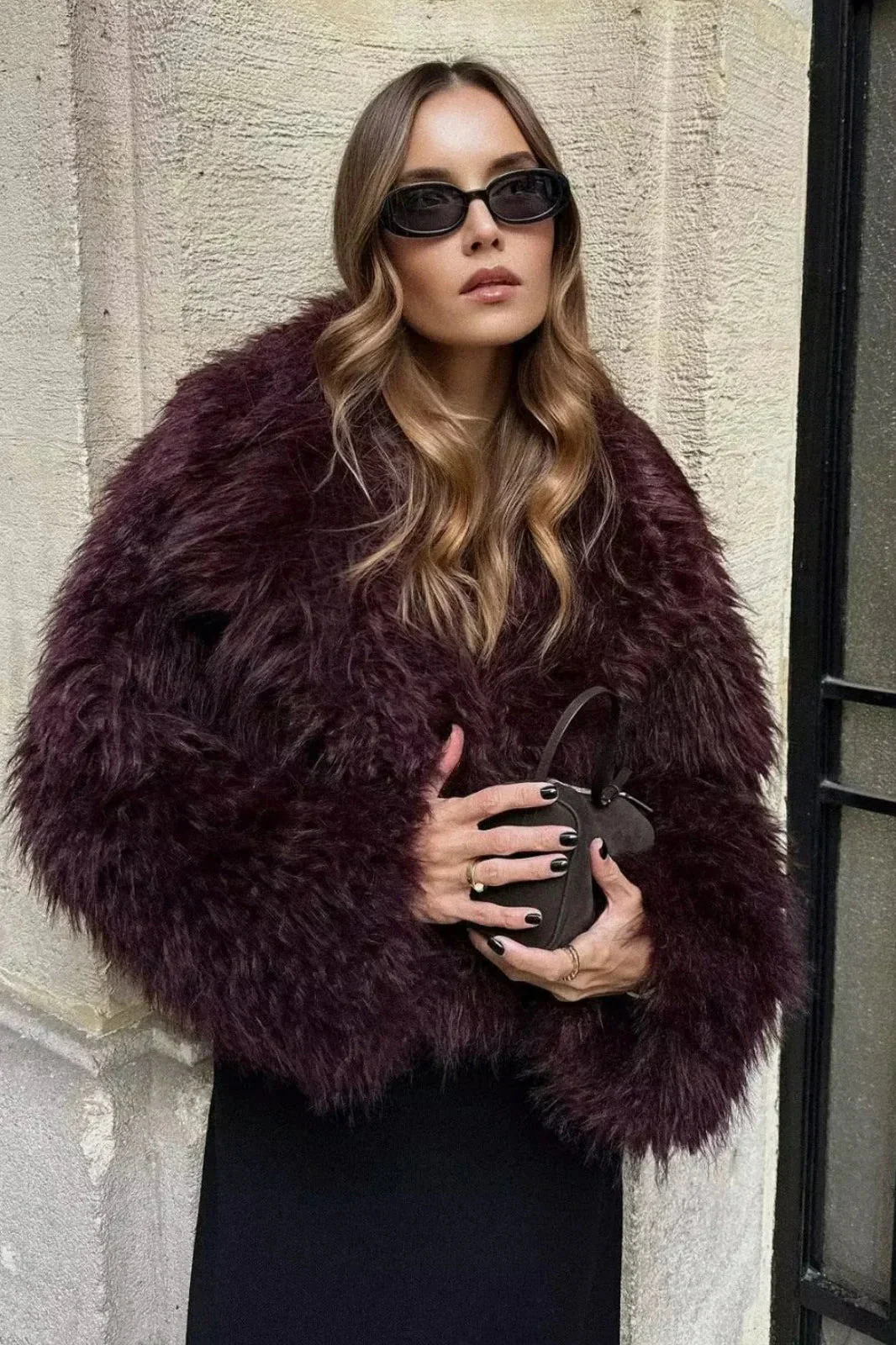 Cropped fluffy jacket in deep wine with a refined notch lapel and subtly voluminous sleeves. Plush, cosy texture and hip-skimming length create a chic layer over denim or evening dresses, adding warm, modern elegance for cooler days.
