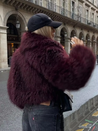 Cropped fluffy jacket in deep wine with a refined notch lapel and subtly voluminous sleeves. Plush, cosy texture and hip-skimming length create a chic layer over denim or evening dresses, adding warm, modern elegance for cooler days.