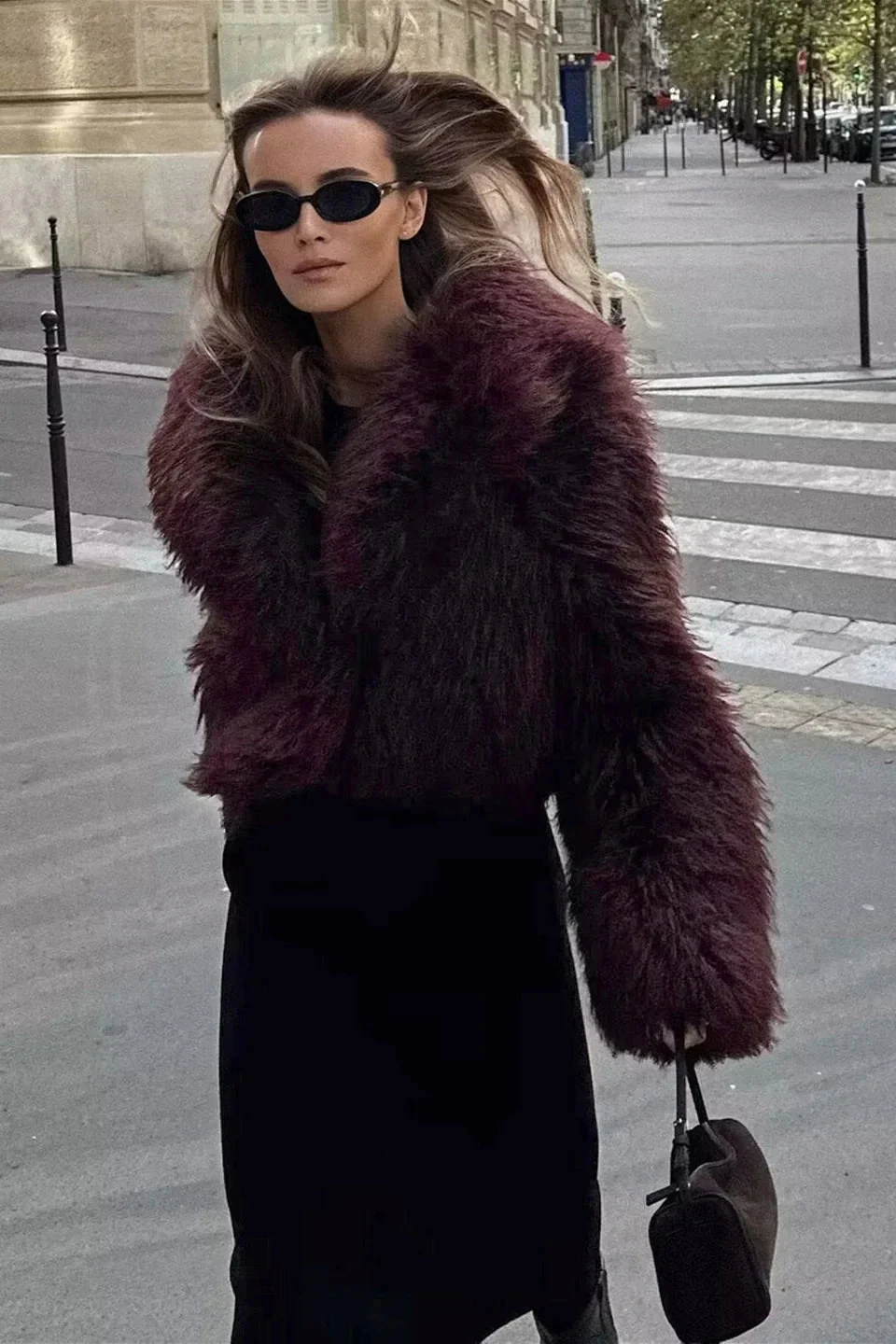 Cropped fluffy jacket in deep wine with a refined notch lapel and subtly voluminous sleeves. Plush, cosy texture and hip-skimming length create a chic layer over denim or evening dresses, adding warm, modern elegance for cooler days.