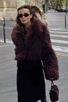 Cropped fluffy jacket in deep wine with a refined notch lapel and subtly voluminous sleeves. Plush, cosy texture and hip-skimming length create a chic layer over denim or evening dresses, adding warm, modern elegance for cooler days.