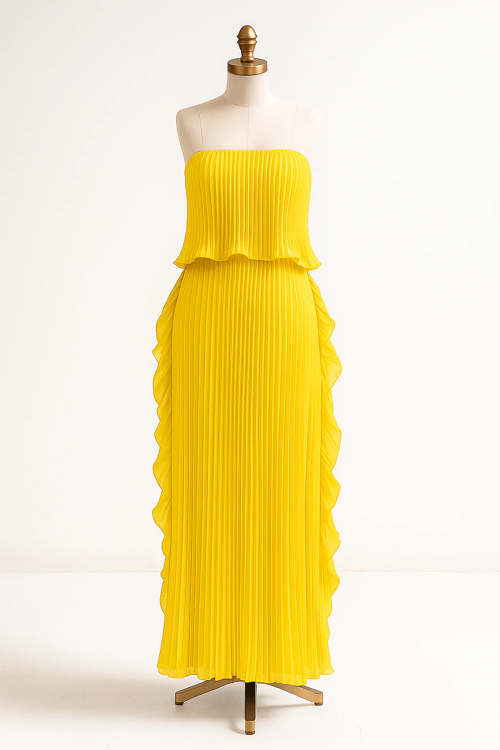 Ravello strapless pleated maxi dress featuring a layered flounce bodice, vertical knife pleats, and cascading side ruffles. Lightweight polyester drape lengthens the silhouette with elegant motion—perfect for weddings, garden parties, and evening events.