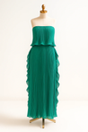 Ravello strapless pleated maxi dress featuring a layered flounce bodice, vertical knife pleats, and cascading side ruffles. Lightweight polyester drape lengthens the silhouette with elegant motion—perfect for weddings, garden parties, and evening events.