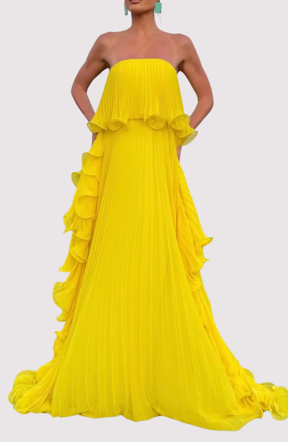 Ravello strapless pleated maxi dress featuring a layered flounce bodice, vertical knife pleats, and cascading side ruffles. Lightweight polyester drape lengthens the silhouette with elegant motion—perfect for weddings, garden parties, and evening events.