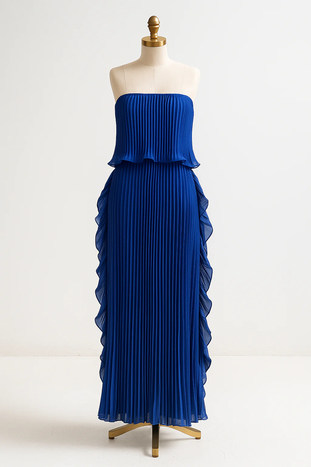 Ravello strapless pleated maxi dress featuring a layered flounce bodice, vertical knife pleats, and cascading side ruffles. Lightweight polyester drape lengthens the silhouette with elegant motion—perfect for weddings, garden parties, and evening events.