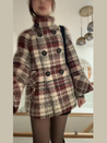 Rose checked wool-blend coat featuring a double-breasted front, high stand collar and softly flared sleeves. Warm beige and burgundy check with a textured finish; a feminine, vintage-leaning silhouette ideal for autumn and winter styling with boots or trousers.
