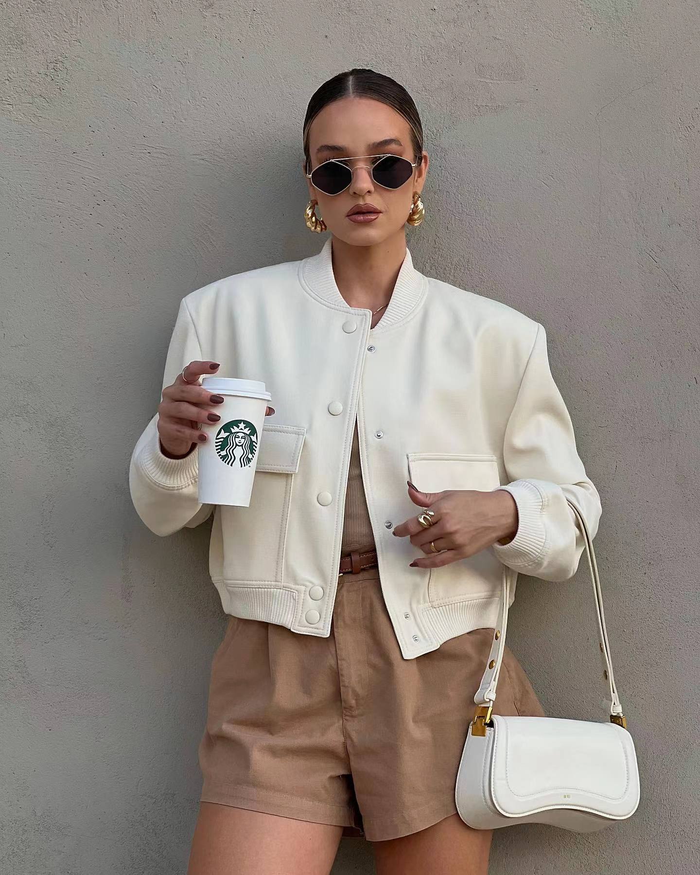 Oversized bomber jacket featuring a ribbed stand collar, ribbed cuffs and hem, clean snap-button front and two large flap pockets. Soft-touch, lightweight feel and relaxed drape make an easy, refined layer over tees, knits or dresses for transitional weather.