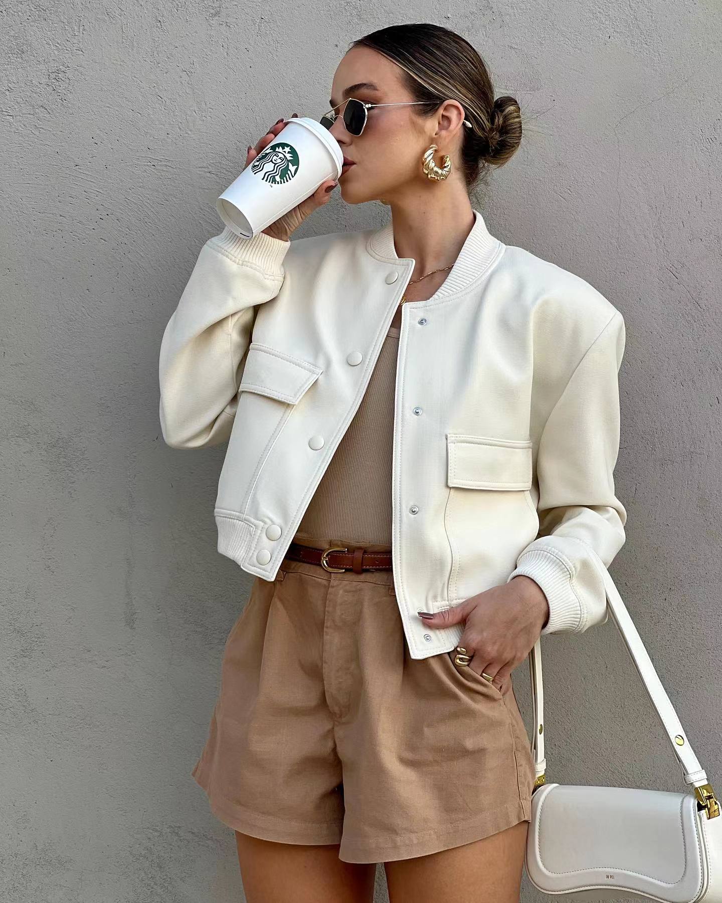 Oversized bomber jacket featuring a ribbed stand collar, ribbed cuffs and hem, clean snap-button front and two large flap pockets. Soft-touch, lightweight feel and relaxed drape make an easy, refined layer over tees, knits or dresses for transitional weather.